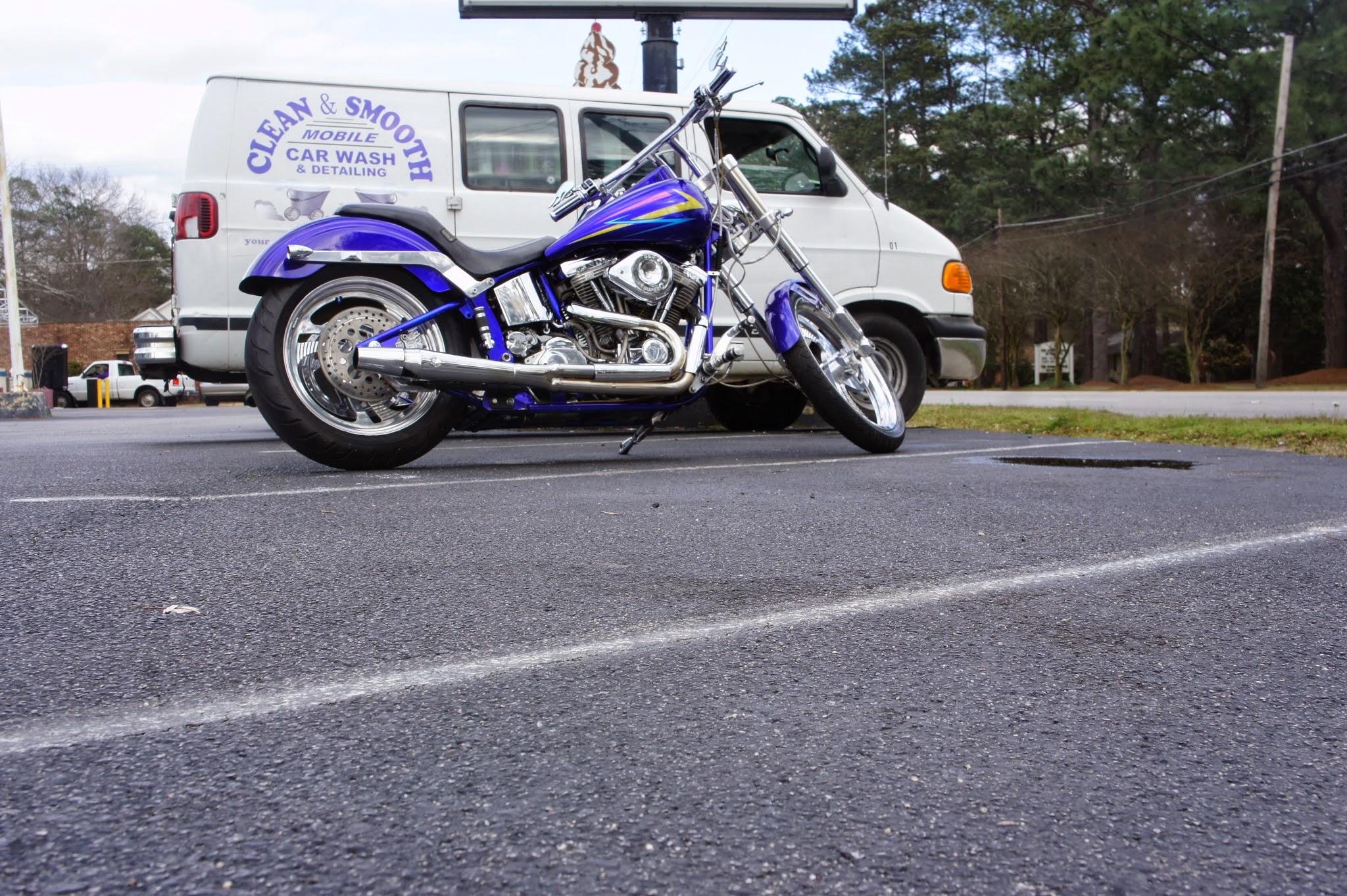 Purple custom motorcycle parked in front of our van